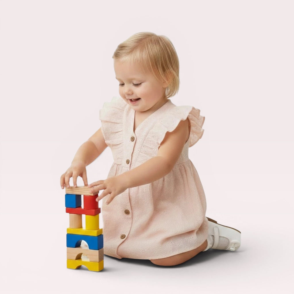 Child playing with colorful building blocks on a white background, with 'LIL LOOM' branding.