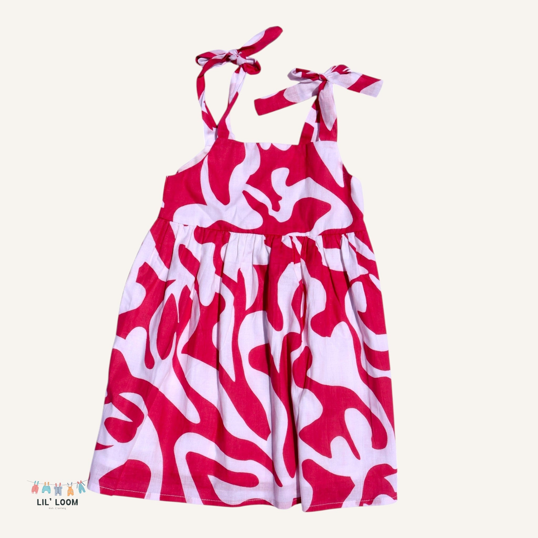 Red and white patterned dress with tied straps 