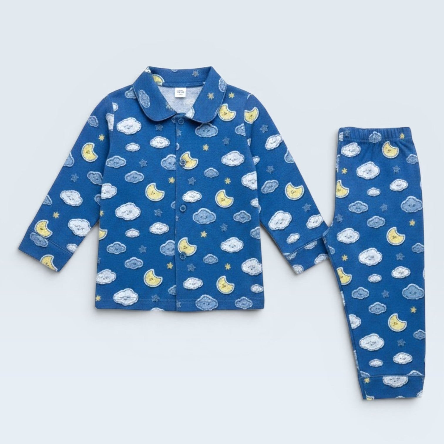 Lilloom blue cotton pajama set with moons, clouds, and stars print. Button-front top and elastic waist pants.