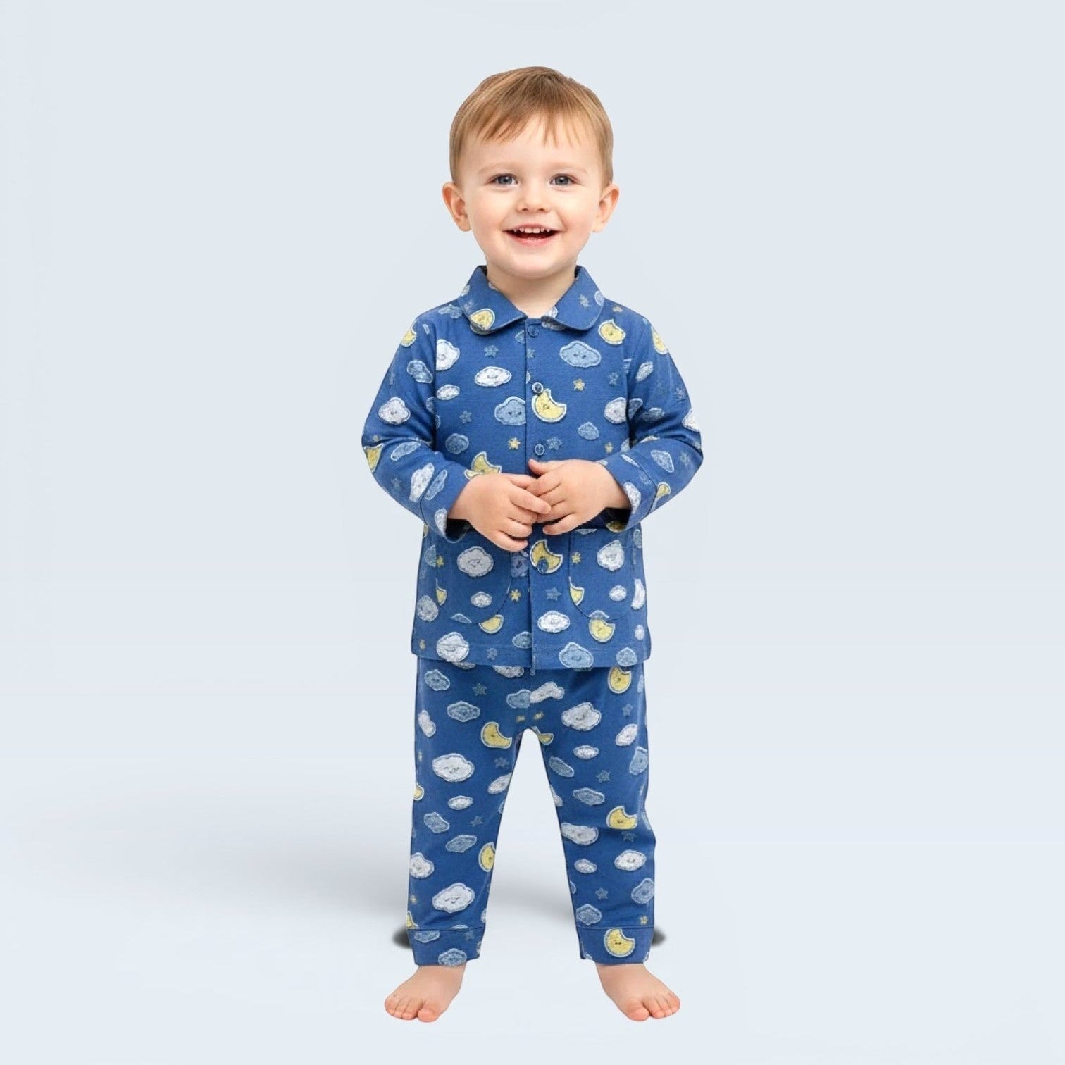 Lilloom blue cotton pajama set with moons, clouds, and stars print for boys. Button-front top and elastic waistband pants.