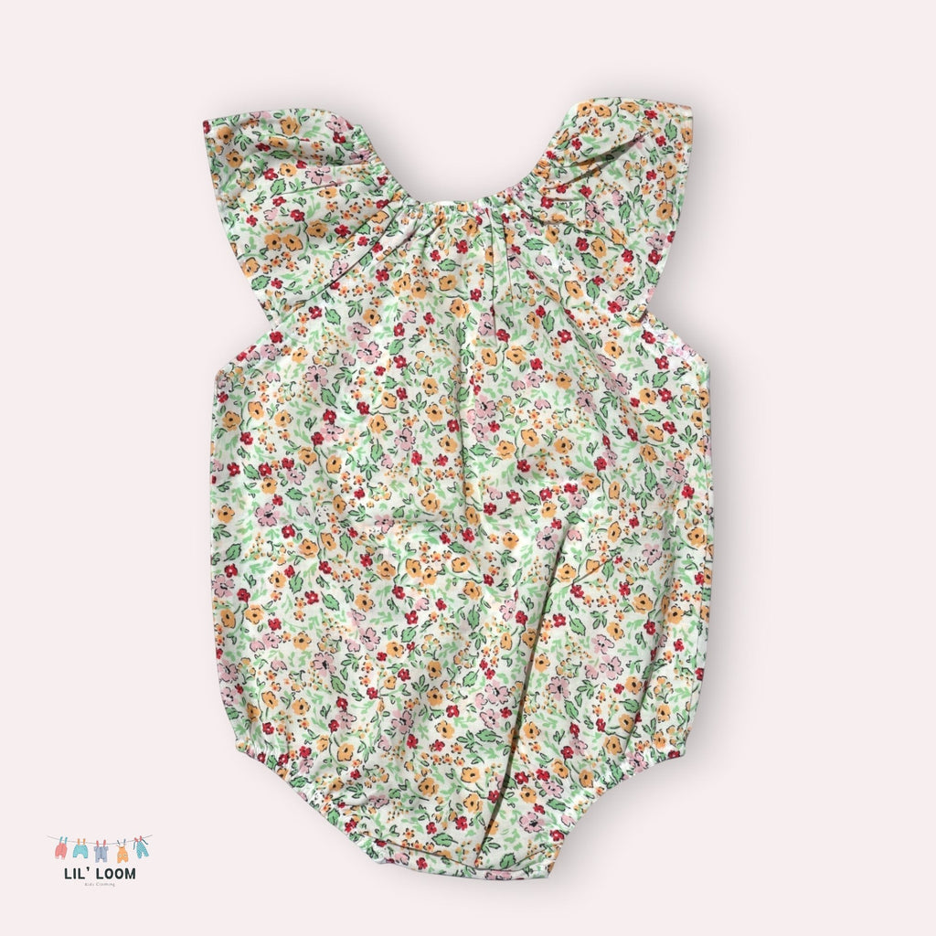 lilloom Wildflower Wishes Onesie, a lightweight cotton infant romper with a delicate floral print and ruffle collar.