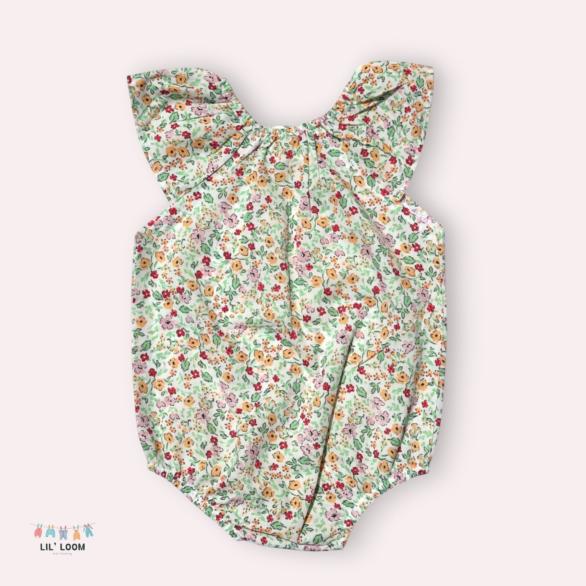 lilloom Wildflower Wishes Onesie, a lightweight cotton infant romper with a delicate floral print and ruffle collar.