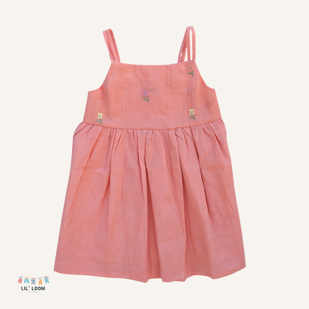 Pink dress with floral embroidery on a white background