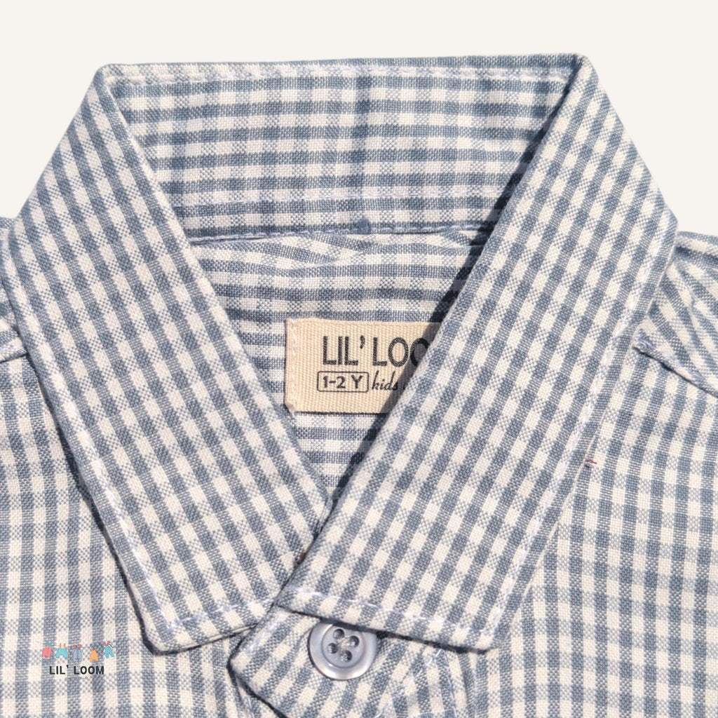 Close-up of a grey and white checkered shirt with a visible brand label 