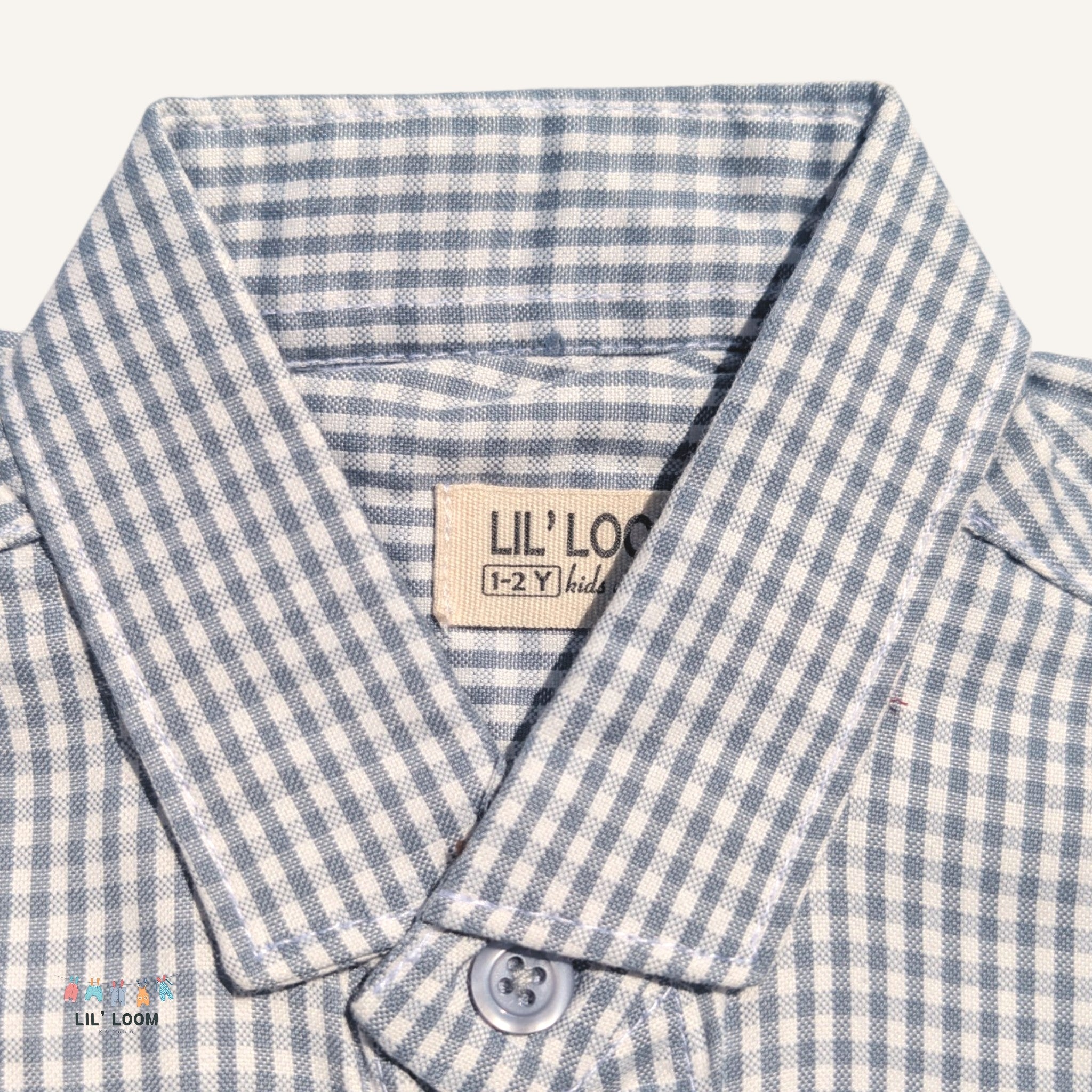 Close-up of a grey and white checkered shirt with a visible brand label 